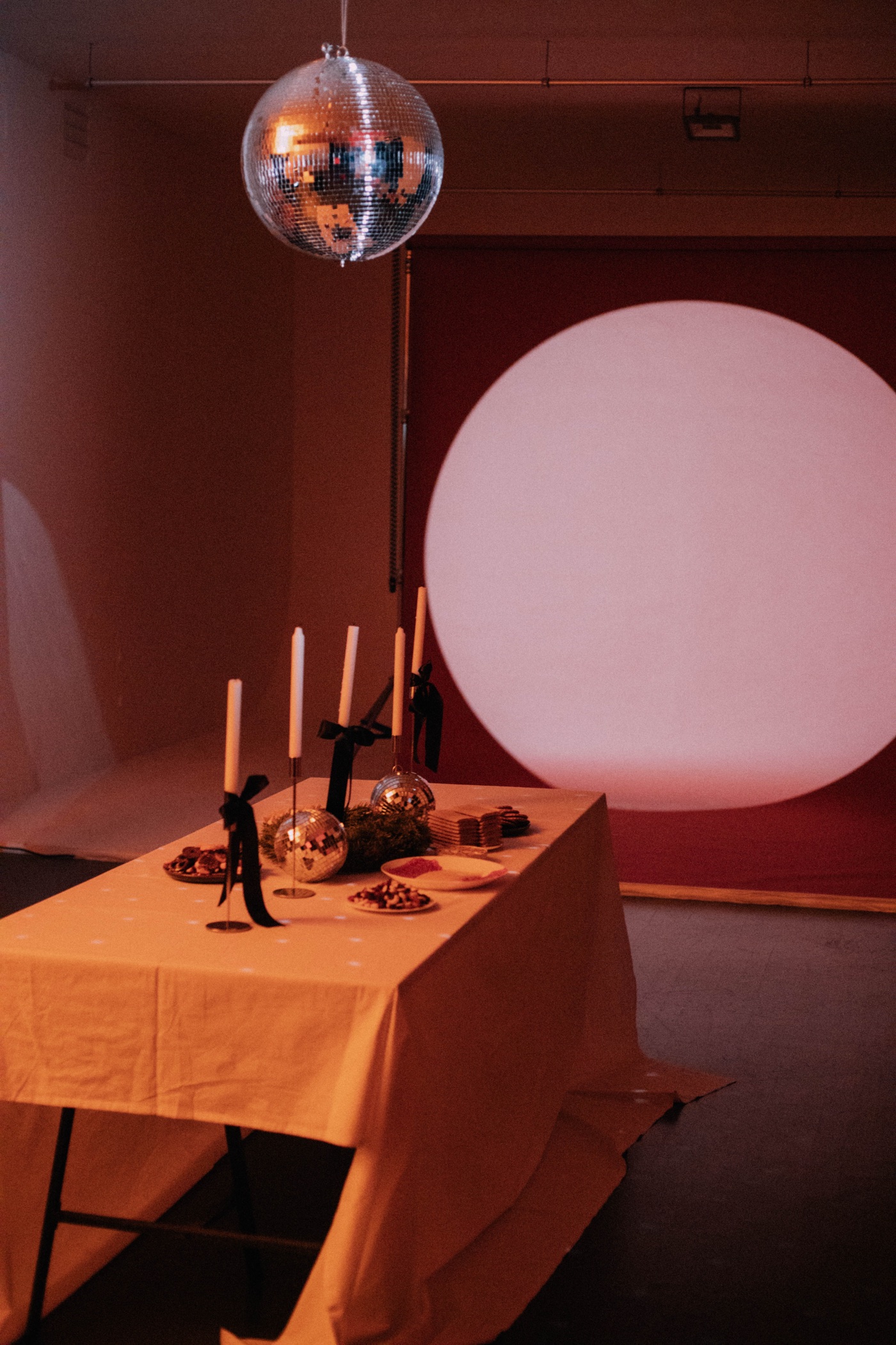 Disco ball and candlelit table set up for an event at IMAGINE Studio
